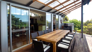 The old and new sections feature expansive outdoor terraces. Upstairs, the deck off the living room and master bedroom overlooks the garden below and boasts city views in the distance.